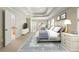 Bright, staged main bedroom features a tray ceiling, sitting area, and ensuite bathroom entrance at 1459 Hickory Branch Nw Trl, Kennesaw, GA 30152