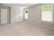 This carpeted bedroom features neutral paint, a closet, and multiple windows at 1459 Hickory Branch Nw Trl, Kennesaw, GA 30152