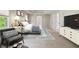 Bright, staged main bedroom features a tray ceiling, sitting area, and ensuite bathroom entrance at 1459 Hickory Branch Nw Trl, Kennesaw, GA 30152