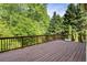 Spacious wooden deck surrounded by lush trees, perfect for enjoying the outdoors at 1459 Hickory Branch Nw Trl, Kennesaw, GA 30152
