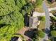 Aerial view of home featuring a spacious deck perfect for outdoor relaxation and entertaining, surrounded by mature trees at 1459 Hickory Branch Nw Trl, Kennesaw, GA 30152