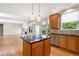 Modern kitchen featuring wood cabinets, granite countertops, stainless steel appliances, island and open view to living room at 1459 Hickory Branch Nw Trl, Kennesaw, GA 30152