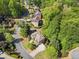 Aerial view of a quiet neighborhood featuring well-maintained homes, mature trees, and cul-de-sac streets at 1459 Hickory Branch Nw Trl, Kennesaw, GA 30152