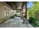Covered patio with stone pillars, ceiling fan, and lovely landscaping provide a relaxing outdoor space at 1459 Hickory Branch Nw Trl, Kennesaw, GA 30152