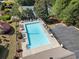 Aerial shot of the pristine community pool with ample seating and a tennis court in the background at 1459 Hickory Branch Nw Trl, Kennesaw, GA 30152