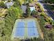 Aerial view of well-maintained tennis courts surrounded by lush greenery, offering a great recreational amenity at 1459 Hickory Branch Nw Trl, Kennesaw, GA 30152