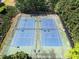 Aerial view of well-maintained tennis courts surrounded by lush greenery, offering a great recreational amenity at 1459 Hickory Branch Nw Trl, Kennesaw, GA 30152