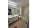 Well-lit bathroom featuring a vanity with storage, tub-shower combo, and tile floors at 290 Azalea Cir, Cumming, GA 30040