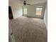 Spacious bedroom featuring neutral walls, carpet floors, ceiling fan, and ample natural light from two windows at 290 Azalea Cir, Cumming, GA 30040