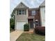 Charming two-story home featuring brick accents, neutral siding, and a convenient one-car garage at 290 Azalea Cir, Cumming, GA 30040