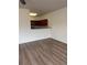 Open-concept living area featuring laminate wood floors and a half wall with views of the kitchen at 290 Azalea Cir, Cumming, GA 30040