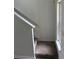 Carpeted stairs with white railing lead to upper level, adjacent to window at 290 Azalea Cir, Cumming, GA 30040