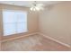 This cozy bedroom has a ceiling fan and a window at 4208 Royal Regency Nw Cir # 9, Kennesaw, GA 30144