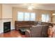 Spacious living room featuring hardwood floors, a fireplace, and large windows for natural light at 4208 Royal Regency Nw Cir # 9, Kennesaw, GA 30144