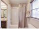 Bathroom with a combined shower-tub and a window for natural light at 445 Big Bend Trl, Sugar Hill, GA 30518