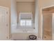 Bathroom featuring a soaking tub, a step-in shower and a basket on the floor at 445 Big Bend Trl, Sugar Hill, GA 30518