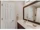 Bright bathroom with a double sink vanity, a large mirror and white door at 445 Big Bend Trl, Sugar Hill, GA 30518