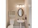 Powder room featuring a pedestal sink and decorative mirror at 445 Big Bend Trl, Sugar Hill, GA 30518