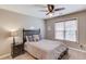Comfortable bedroom with ceiling fan, dark wood furniture and illuminated moon decor at 445 Big Bend Trl, Sugar Hill, GA 30518