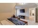 Cozy bedroom featuring a flat-screen TV, comfortable chair, and neutral tones at 445 Big Bend Trl, Sugar Hill, GA 30518