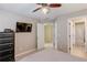 Bedroom featuring a ceiling fan, and easy access to the ensuite bathroom at 445 Big Bend Trl, Sugar Hill, GA 30518