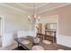 Formal dining room with stylish chandelier and a view into the foyer at 445 Big Bend Trl, Sugar Hill, GA 30518