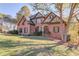 Traditional brick home with well-maintained lawn, landscaping and trees at 445 Big Bend Trl, Sugar Hill, GA 30518