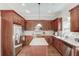 A well-lit kitchen with a center island and stainless steel appliances at 445 Big Bend Trl, Sugar Hill, GA 30518