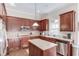 A well-lit kitchen with a center island and stainless steel appliances at 445 Big Bend Trl, Sugar Hill, GA 30518