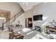 Bright living room with fireplace, tall ceilings, and staircase at 445 Big Bend Trl, Sugar Hill, GA 30518