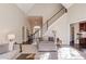 Bright living room with fireplace, tall ceilings, and staircase at 445 Big Bend Trl, Sugar Hill, GA 30518