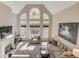 Bright living room with a fireplace, tall windows and comfortable furniture at 445 Big Bend Trl, Sugar Hill, GA 30518