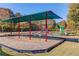 Community playground shaded with swings, slides, and play structures for outdoor Gathering enjoyment at 445 Big Bend Trl, Sugar Hill, GA 30518