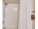 This well-lit shower features white tiling and a rainfall shower head at 445 Big Bend Trl, Sugar Hill, GA 30518
