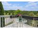 Cozy balcony featuring an outdoor table and chairs, perfect for enjoying the serene views at 639 Puckett Se Rd, Emerson, GA 30137