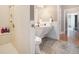 Modern bathroom with stone tile flooring, glass shower, and pedestal sink at 639 Puckett Se Rd, Emerson, GA 30137