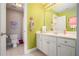 Bright bathroom with a vibrant green wall, single sink, and tile flooring at 639 Puckett Se Rd, Emerson, GA 30137