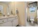 Cozy bathroom featuring tile flooring, white cabinets, and a window view at 639 Puckett Se Rd, Emerson, GA 30137