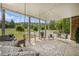 Inviting covered patio with cozy seating, outdoor grill, and a view of the expansive backyard at 639 Puckett Se Rd, Emerson, GA 30137