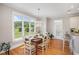 Sunlit dining area with large windows offering views of landscaped outdoors and classic hardwood flooring at 639 Puckett Se Rd, Emerson, GA 30137