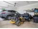 Spacious garage with cars, golf cart, lawnmower, and ample storage at 639 Puckett Se Rd, Emerson, GA 30137