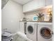 Functional laundry room with storage cabinets, countertops, modern washer and dryer, and ample space at 639 Puckett Se Rd, Emerson, GA 30137
