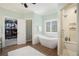 Serene main bathroom with a freestanding tub, walk-in shower, and access to a spacious walk-in closet at 639 Puckett Se Rd, Emerson, GA 30137
