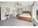Tranquil main bedroom with hardwood floors, tray ceiling, large windows, and comfortable furnishings at 639 Puckett Se Rd, Emerson, GA 30137