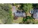 Stunning aerial view of home with lush greenery, long driveway, and neighboring pool at 10 Wyndham Dr, Sandy Springs, GA 30328