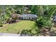 Aerial view of a well-maintained home with a spacious yard, mature trees, and a classic design at 10 Wyndham Dr, Sandy Springs, GA 30328