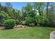 Secluded backyard with lush greenery and a charming seating area at 10 Wyndham Dr, Atlanta, GA 30328