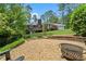 Beautifully landscaped backyard with fire pit area and view of the home at 10 Wyndham Dr, Sandy Springs, GA 30328