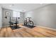 Finished basement area featuring a workout bench, bike, and wood flooring at 10 Wyndham Dr, Sandy Springs, GA 30328