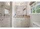 Bathroom with a granite vanity, large mirror, and tiled walk-in shower at 10 Wyndham Dr, Sandy Springs, GA 30328